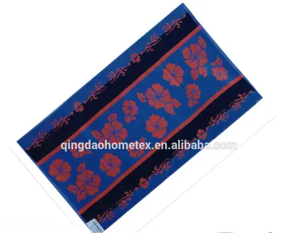 Blue beach towel with orange floral print, shown diagonally with BSCI and OEKO-TEX certification logos below