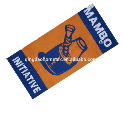 Orange and navy printed beach towel with MAMBO INITIATIVE graphics, tilted on white background