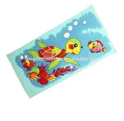 Colorful beach towel with printed cartoon sea turtle and fish design on light blue background
