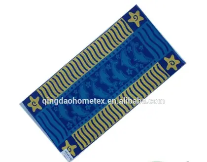Blue and yellow beach towel with dolphin and starfish patterns, shown tilted with certification logos below