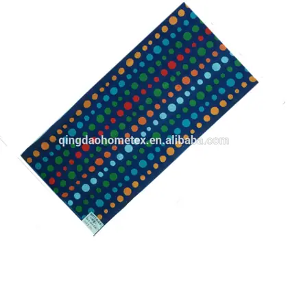 Rectangular navy fabric towel printed with multicolored polka dots, displayed diagonally on a white background.