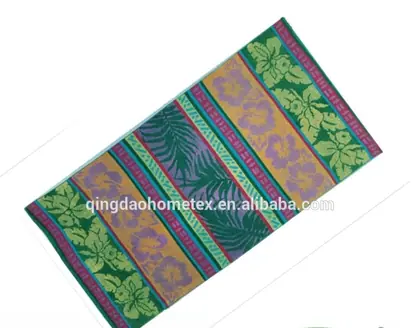 Colorful striped beach towel with floral and leaf jacquard patterns, shown diagonally with BSCI and OEKO-TEX logos below