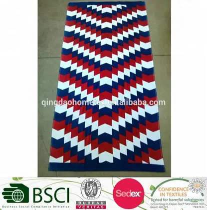Red, white and blue chevron-patterned beach towel laid flat on a tiled floor