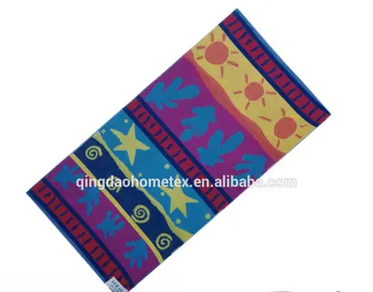 Colorful printed beach towel with stars, suns and swirls, shown diagonally with BSCI and OEKO-TEX logos below