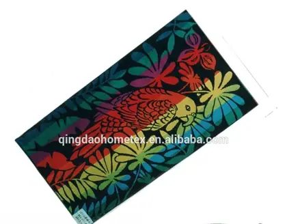 Colorful printed towel with parrot and floral pattern lying on a white background