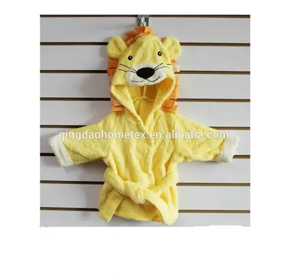 Yellow lion-themed hooded baby bathrobe with ears and mane hanging on a slatted wall