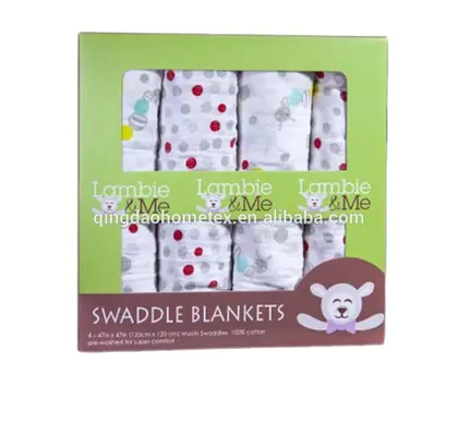 Boxed set of four patterned cotton swaddle blankets with green retail packaging