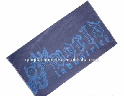 Dark navy towel with light blue cartoon graphic print shown diagonally, with BSCI and Confidence in Textiles certification logos below