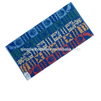 Colorful beach towel with seahorse, shell, starfish and wave patterns in blue, green, orange and red, on white background