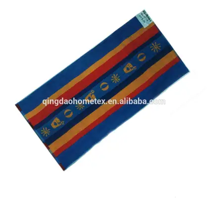 Striped beach towel in blue, red and orange with printed sun and shell motifs, angled on white background