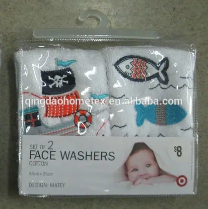 Packaged set of two cotton face washers with embroidered pirate ship and fish designs in a hanging blister pack