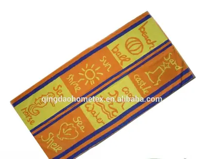 Beach towel with orange, yellow and blue striped panels printed with sun, seahorse, shell and beach-themed words, shown diagonally with BSCI and Confidence in Textiles logos below