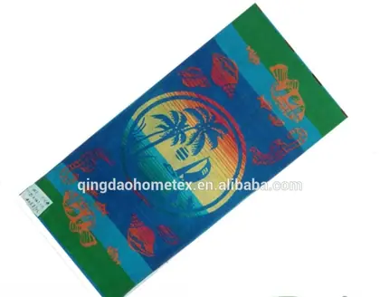 Printed beach towel with tropical palm and fish design, tilted, with BSCI and Oeko-Tex logos below and Alibaba watermark
