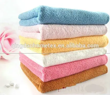 Stack of folded microfiber towels in blue, white, yellow, pink, and brown