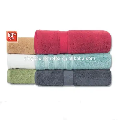 Stack of rolled towels in red, beige, white, teal, green, and dark gray on a white background