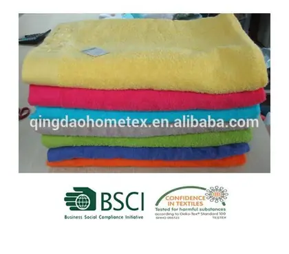 Stack of folded towels in yellow, pink, blue, gray, green, orange, with BSCI and Oeko-Tex logos below