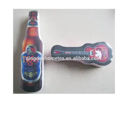 Two printed fabric items shaped like a beer bottle and a guitar, lying on a plain surface