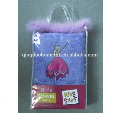 Purple girls towel pack with princess design and feather trim in clear plastic bag on gray surface
