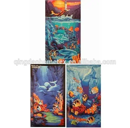 Three printed beach towel designs showing underwater scenes with dolphins, tropical fish, coral reefs and a lighthouse sunset