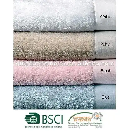 Stacked folded towels in white, putty, blush pink, and blue with burned-in color labels