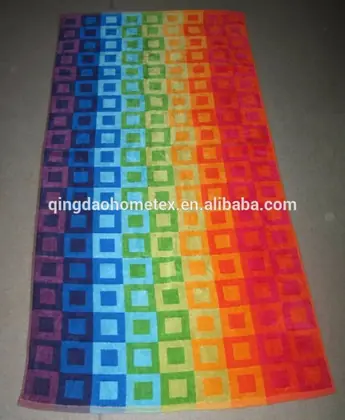 Rainbow beach towel with checkered square pattern in red, orange, yellow, green, blue and purple bands, laid flat