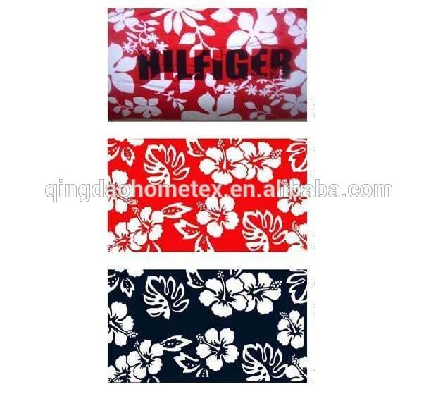 Three stacked fabric swatches with white hibiscus floral prints on red and navy backgrounds, one printed with text