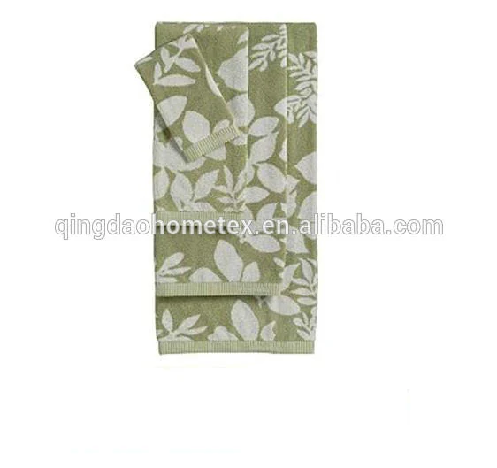 Sage green towel set with white leaf print, folded bath towel, hand towel and washcloth on white background