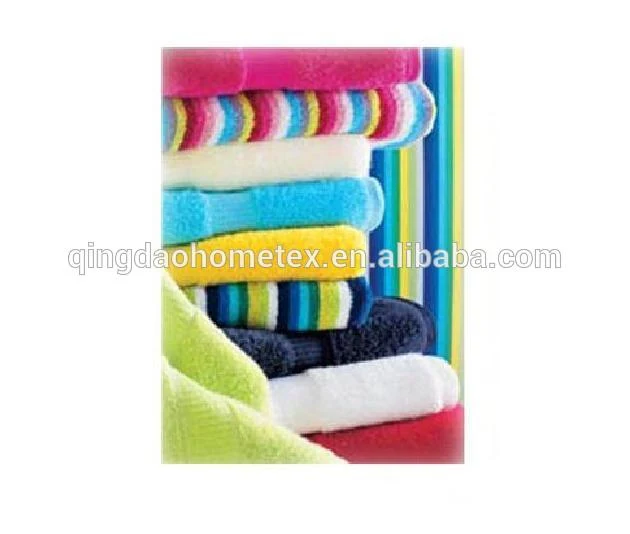 Stack of colorful folded towels in pink, blue, yellow, green, and striped patterns against a striped background