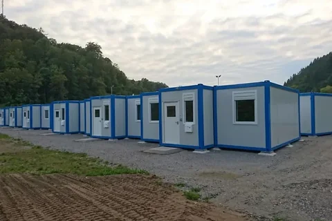 Row of container dormitory units forming a completed accommodation camp