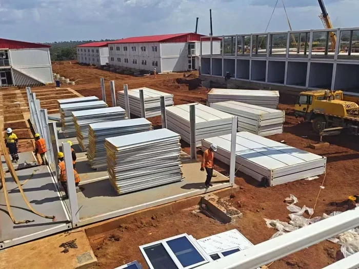 Flat-packed building panels and members prepared for container loading