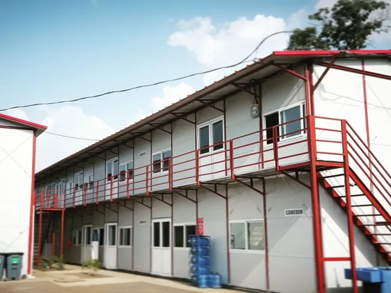Two-storey prefab modular building with external red steel staircase