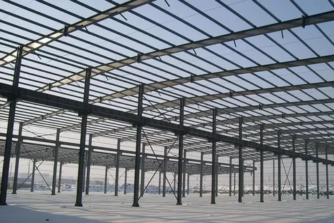 Clear-span steel portal frame interior of a completed warehouse building