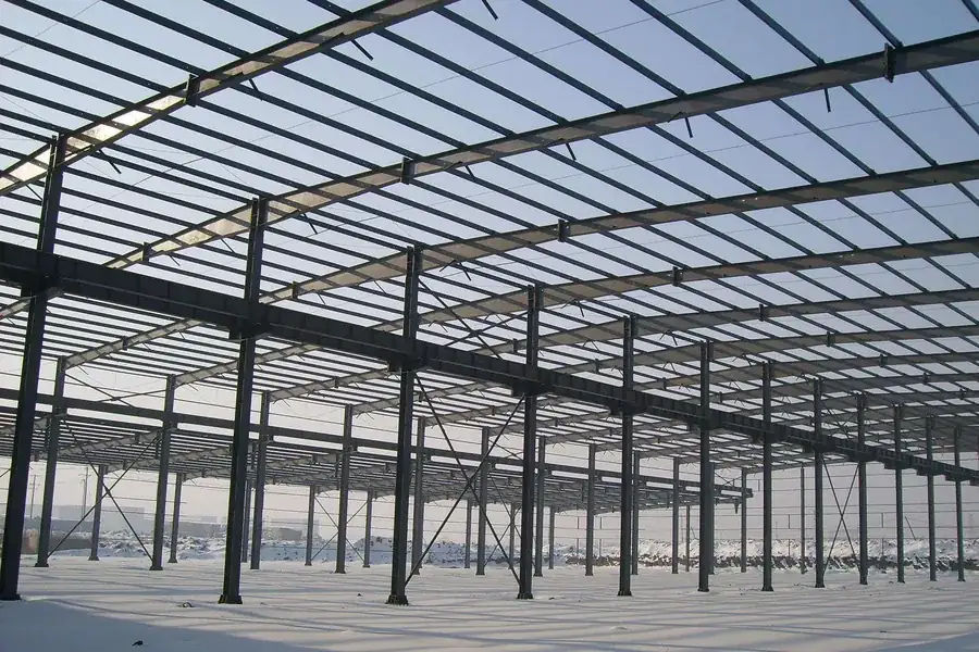 Clear-span steel portal frame interior of a pre-engineered industrial building