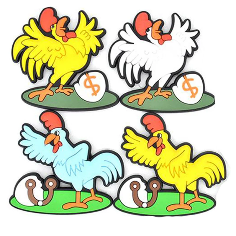 Four soft PVC magnets showing yellow and white roosters and hens with eggs on green grass bases