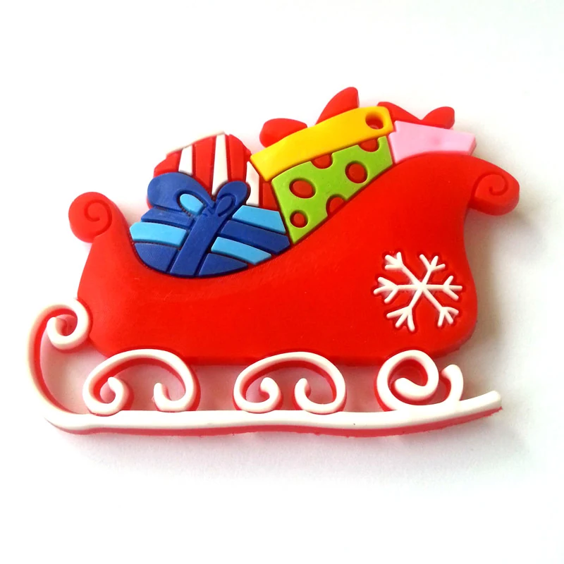 Soft PVC magnet of a red sleigh with white runners loaded with wrapped gift boxes