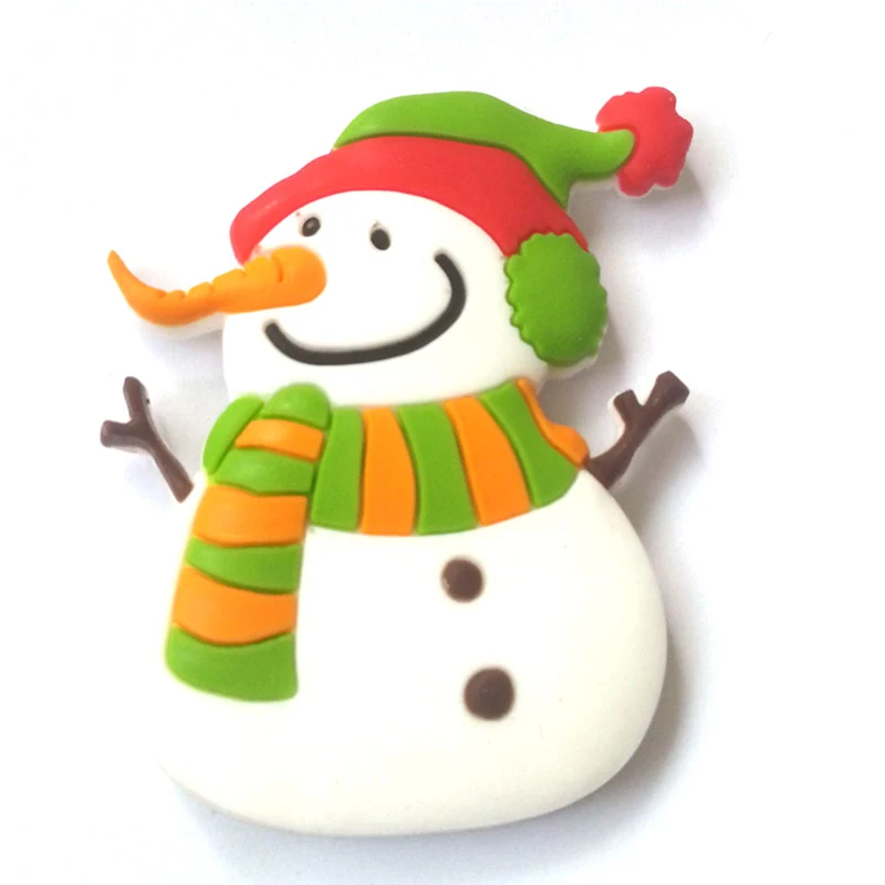 Soft PVC magnet of a snowman in a green and red knitted hat with an orange striped scarf and twig arms