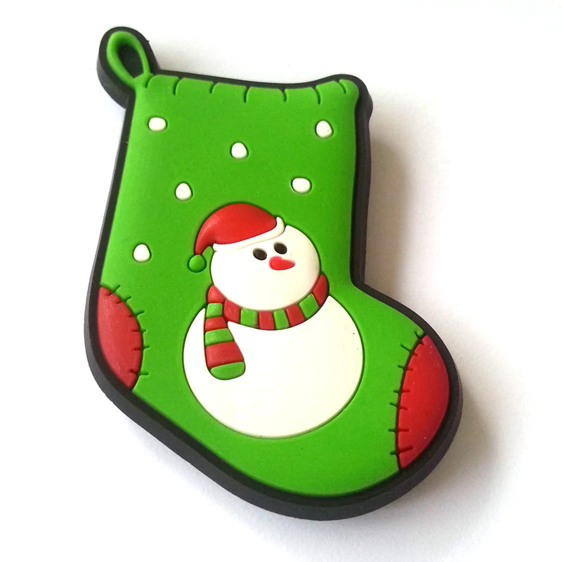 Soft PVC magnet of a green Christmas stocking with a white snowman wearing a red and green hat
