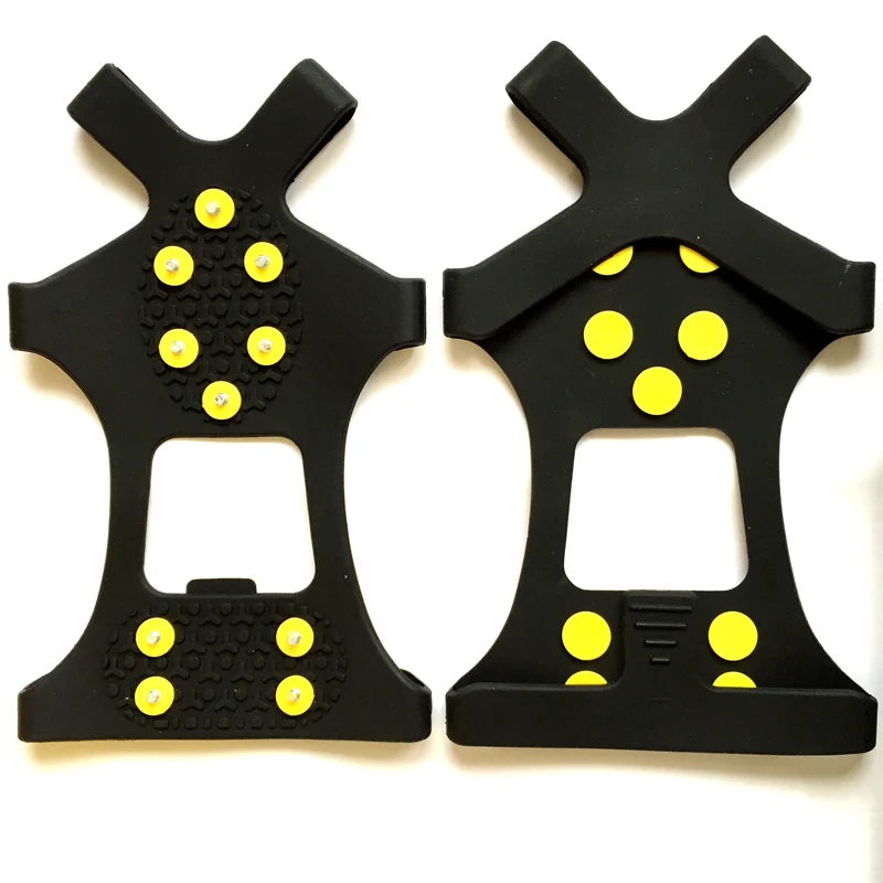 Pair of black moulded rubber ice grips with yellow studs designed to stretch over the sole of a boot