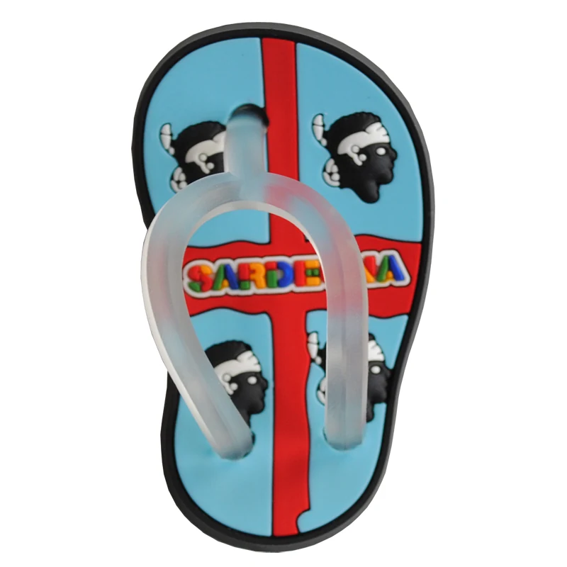 Blue soft PVC flip flop magnet with a red stripe the Sardegna four moors emblem and a clear moulded toe strap