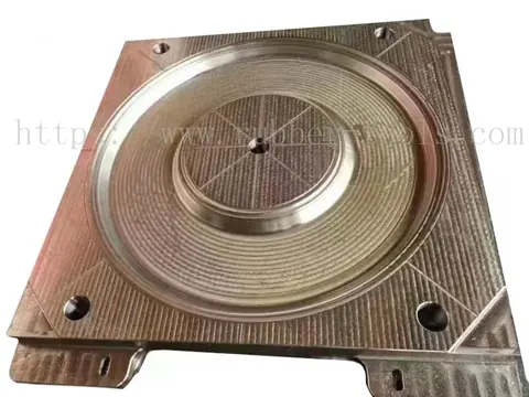 Machined steel mould plate with a stepped circular cavity