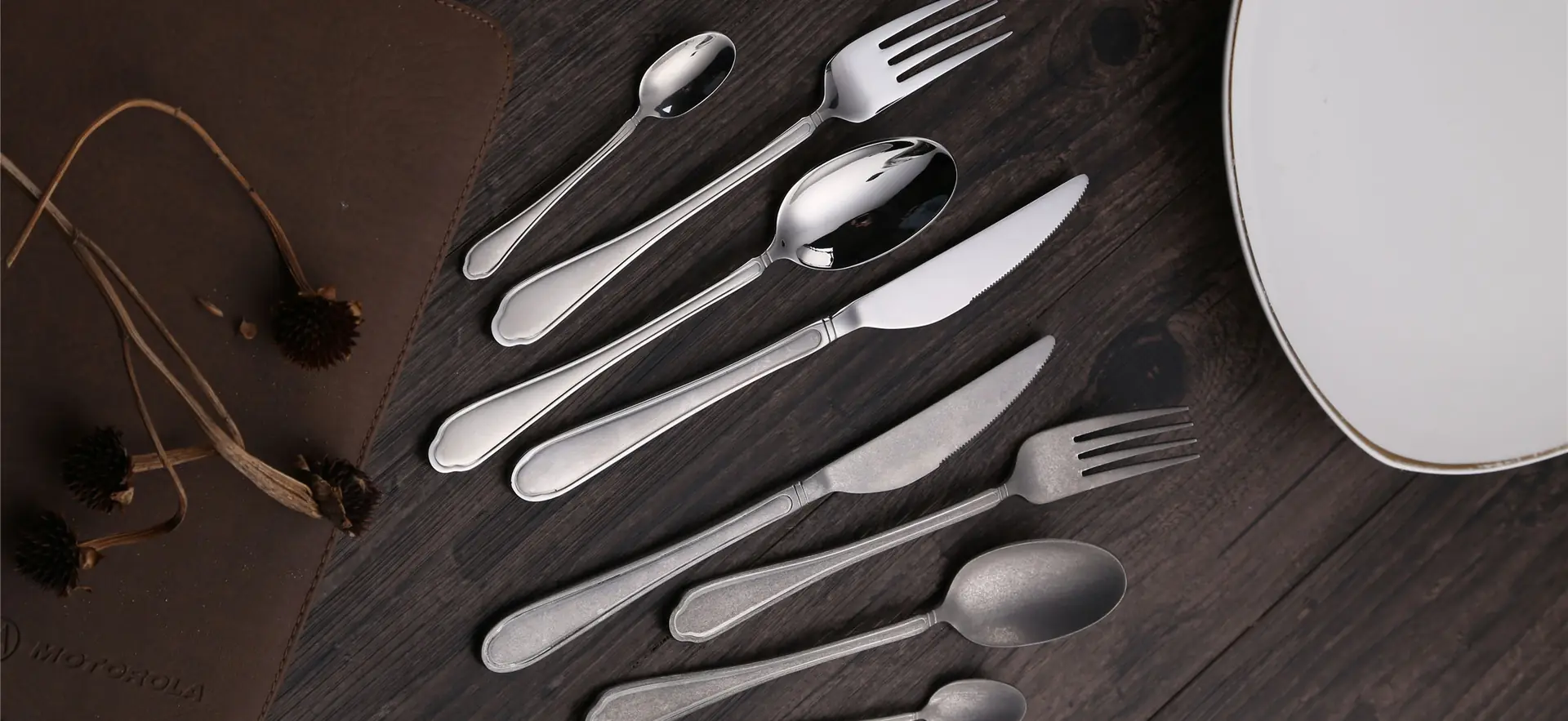Cutlery set arranged on a dark wooden table