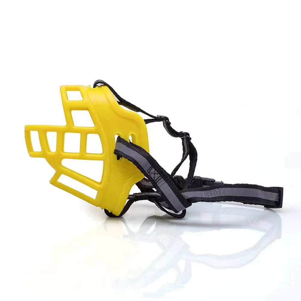 Yellow plastic dog muzzle with black adjustable straps on a white background