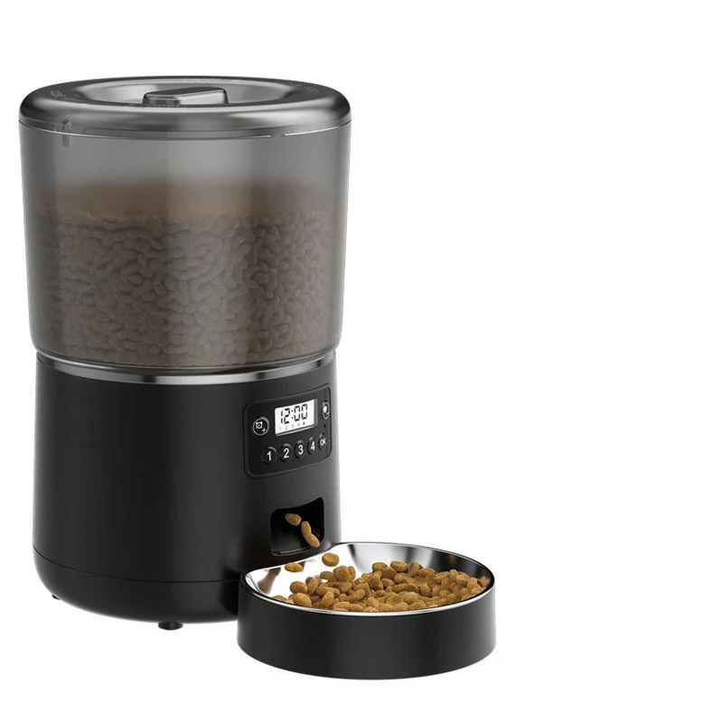 Black automatic pet feeder with a digital display and clear hopper filled with dry food, dispensing into a stainless steel bowl.