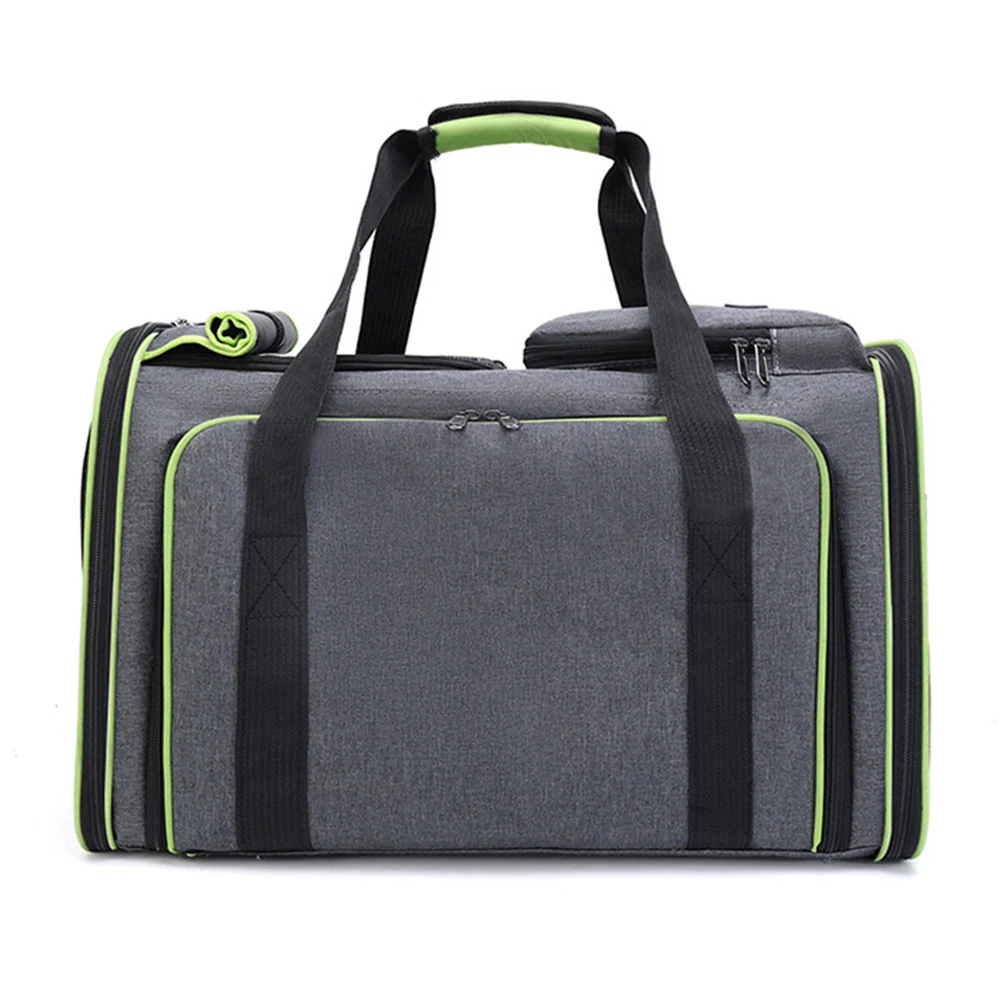 Grey fabric duffel bag with black handles and green zipper accents on a white background