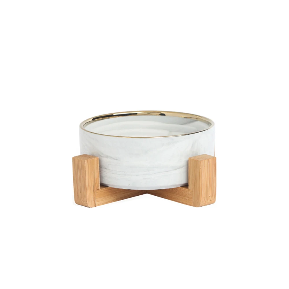 Marble bowl with gold rim on wooden stand
