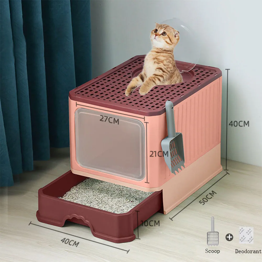 Pink and maroon enclosed cat litter box with a cat sitting on top, featuring a pull-out tray and a scoop.