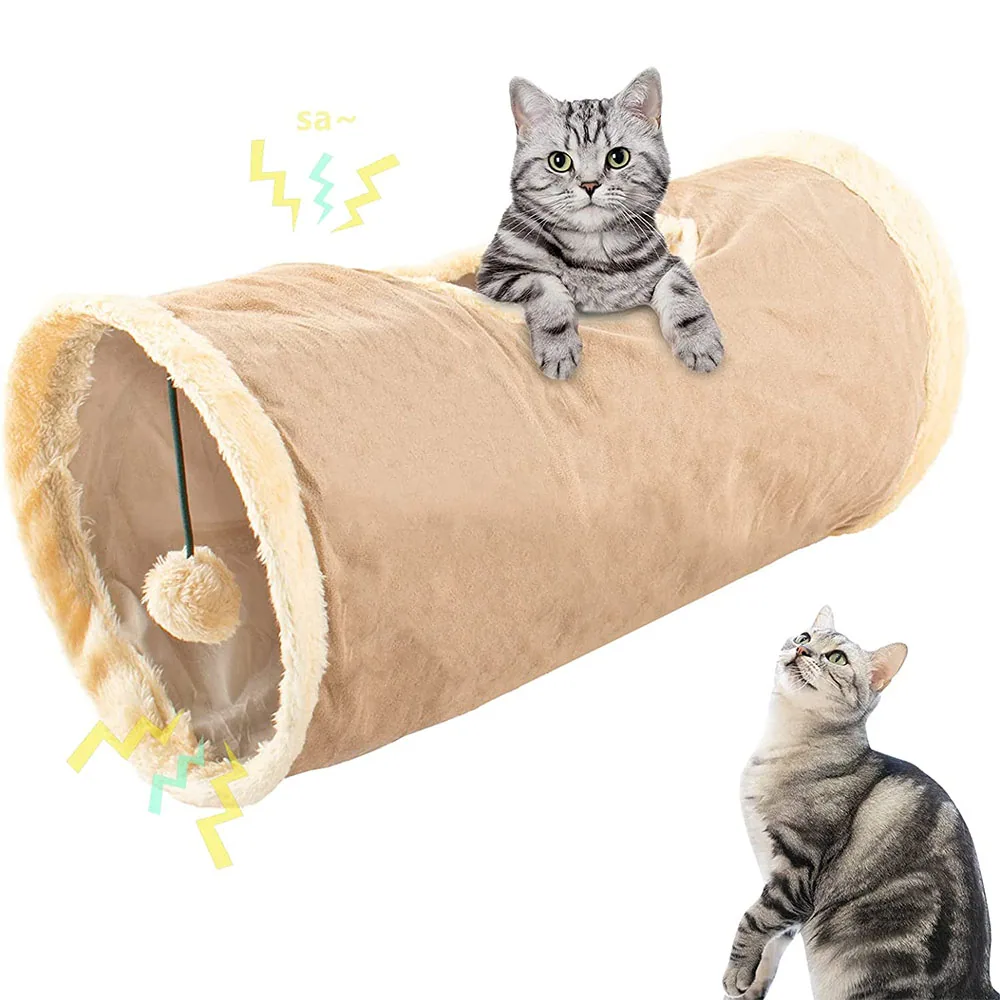 A beige cylindrical cat tunnel toy with plush trim and a dangling ball, shown with two tabby cats.