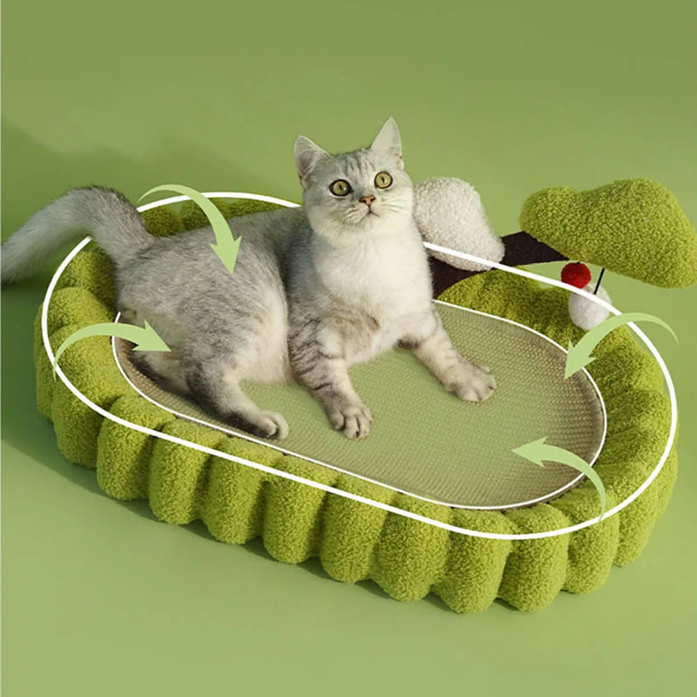 A grey and white cat relaxing on a green, textured cat scratcher bed.