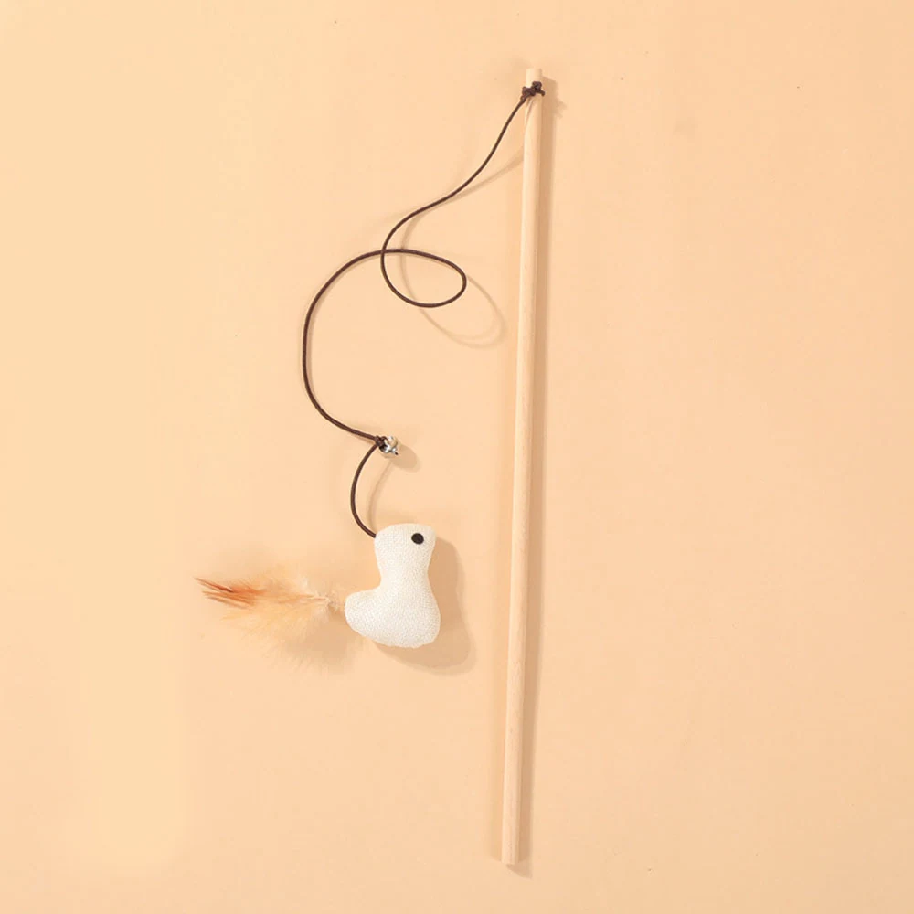 A wooden cat wand toy with a white bird attachment and feather on a beige background