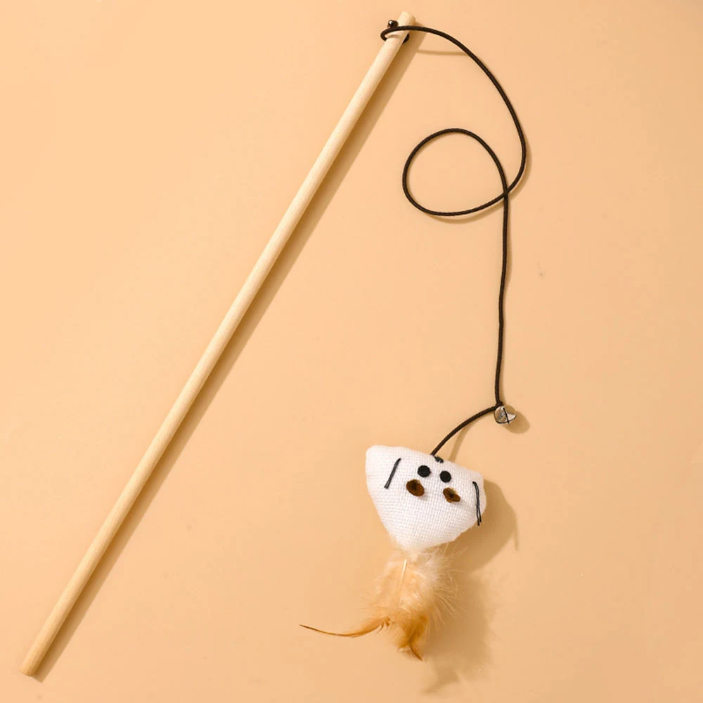 Wooden wand with a dangling plush mouse toy and feathers on a beige background